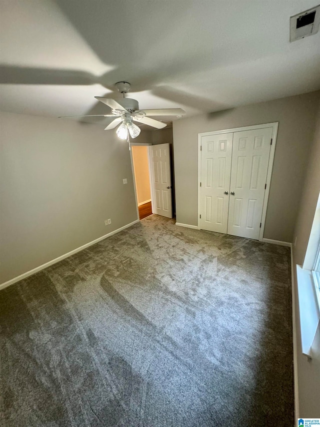 unfurnished bedroom featuring ceiling fan, carpet floors, and a closet