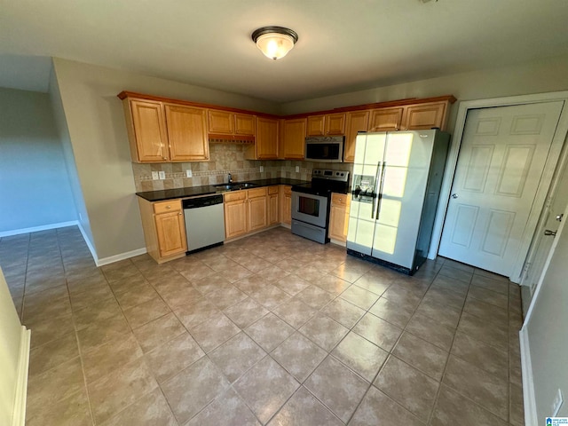 kitchen featuring appliances with stainless steel finishes, backsplash, and sink