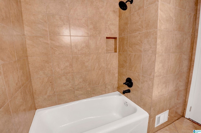 bathroom with tile patterned floors and tiled shower / bath combo