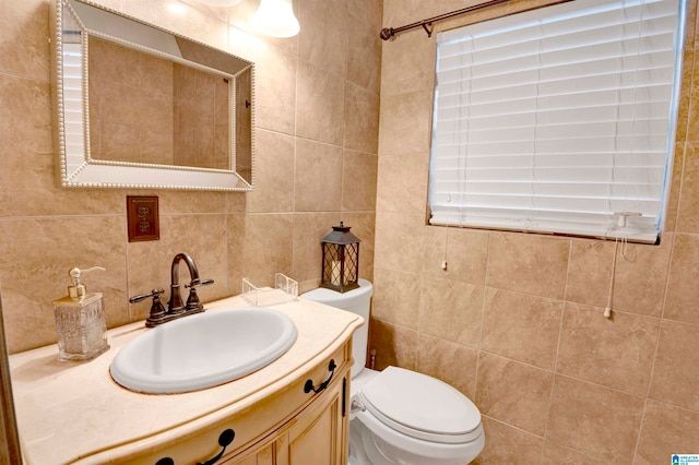 bathroom with decorative backsplash, vanity, tile walls, and toilet