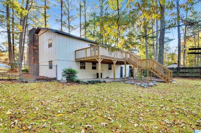 rear view of property with a yard and a deck