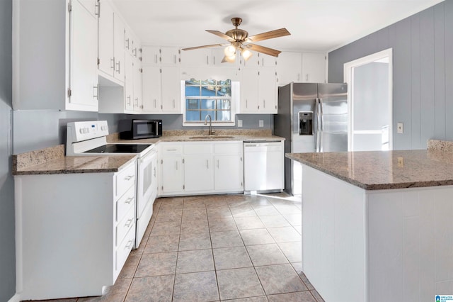 kitchen featuring white cabinetry, sink, ceiling fan, dark stone countertops, and white appliances