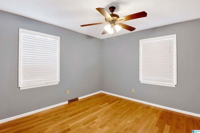 empty room featuring ceiling fan and hardwood / wood-style flooring