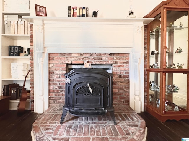 interior details with a wood stove and hardwood / wood-style floors