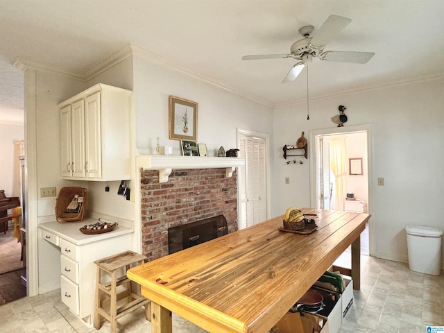 dining space featuring ceiling fan and crown molding