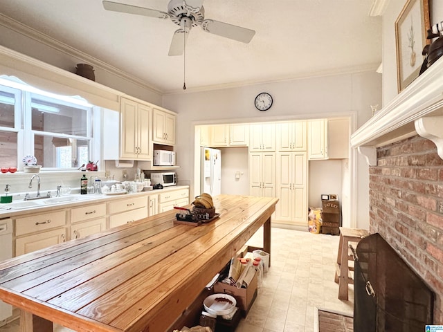 kitchen with ornamental molding and cream cabinets