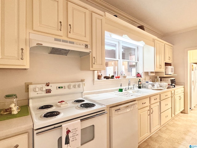 kitchen with sink, white appliances, ornamental molding, and cream cabinets