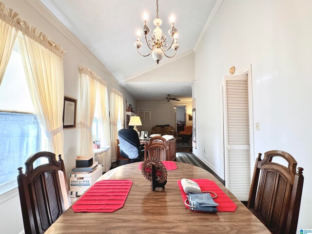 dining space featuring crown molding, ceiling fan with notable chandelier, vaulted ceiling, and hardwood / wood-style flooring