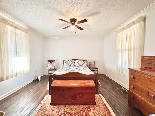 bedroom with ceiling fan, dark hardwood / wood-style flooring, crown molding, and a textured ceiling