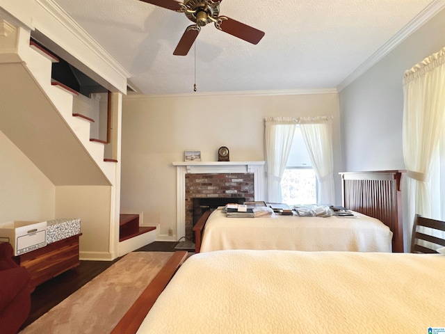 bedroom with ornamental molding, a textured ceiling, ceiling fan, and dark wood-type flooring