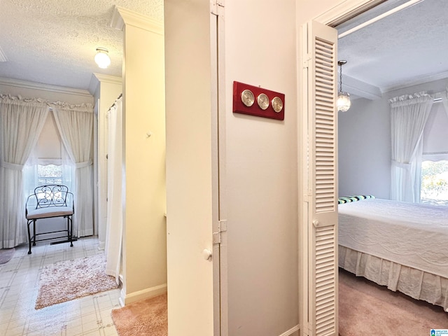 corridor featuring a wealth of natural light and a textured ceiling