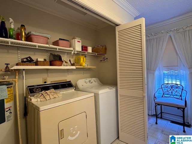 laundry area featuring washing machine and dryer, ornamental molding, and water heater