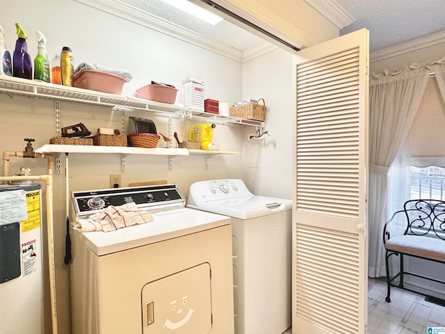 clothes washing area featuring a textured ceiling, electric water heater, washing machine and dryer, and crown molding