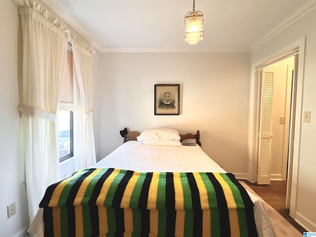 bedroom featuring a closet, dark wood-type flooring, and ornamental molding