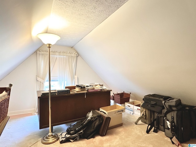 carpeted home office featuring a textured ceiling and vaulted ceiling