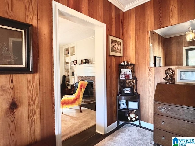 corridor with dark hardwood / wood-style floors, ornamental molding, and wood walls