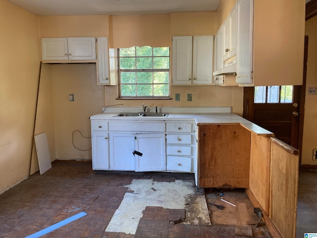 kitchen with white cabinets, plenty of natural light, and sink