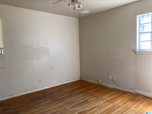 spare room featuring hardwood / wood-style floors and ceiling fan