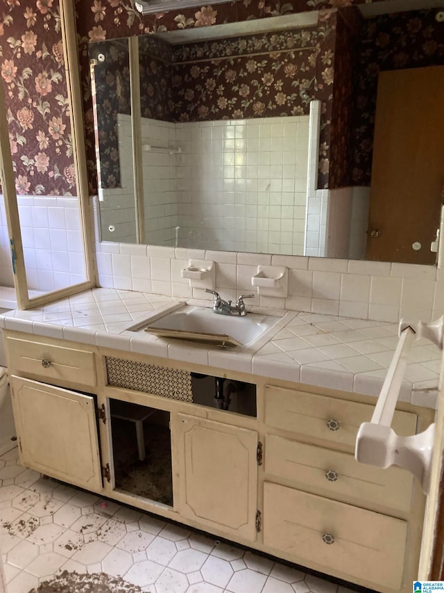 bathroom with decorative backsplash and vanity