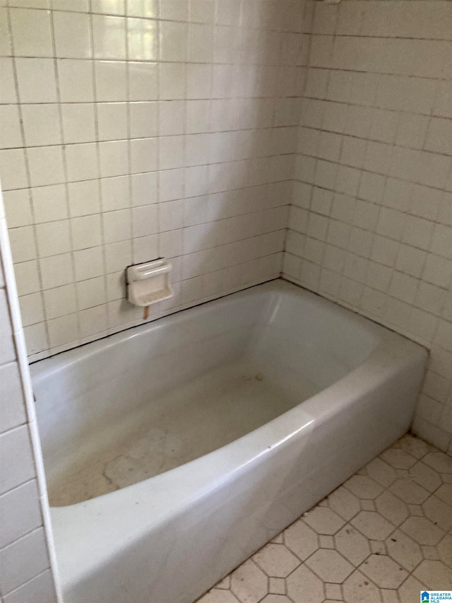 bathroom featuring a washtub and tile patterned floors