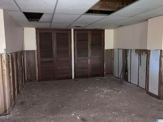 basement with a paneled ceiling