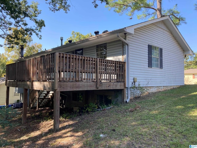 view of home's exterior featuring a yard and a deck