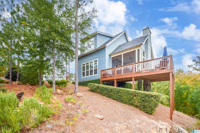 back of property featuring a wooden deck and ceiling fan