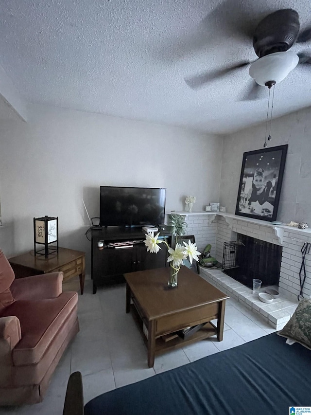 living room featuring a fireplace, a textured ceiling, and ceiling fan