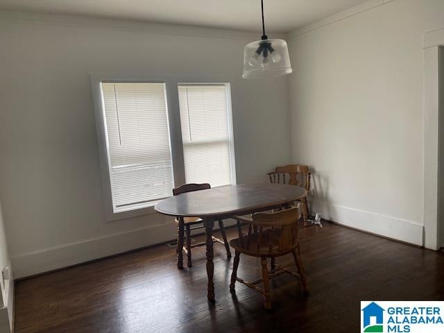 dining room with dark hardwood / wood-style flooring and ornamental molding