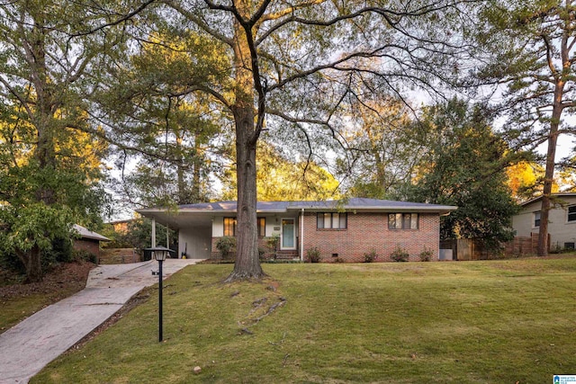 single story home featuring a front lawn and a carport