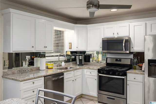 kitchen with white cabinets, appliances with stainless steel finishes, crown molding, and sink