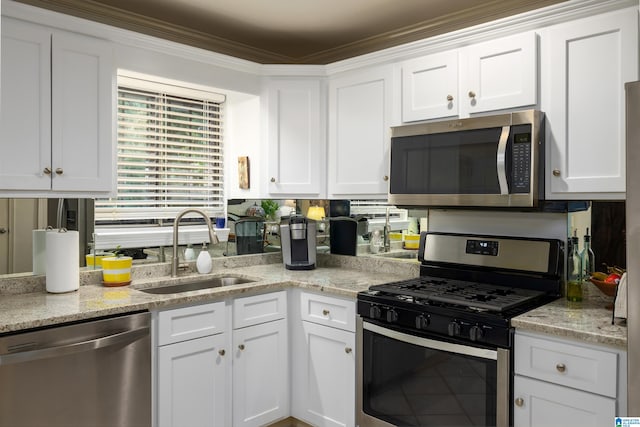 kitchen featuring crown molding, sink, white cabinetry, and stainless steel appliances