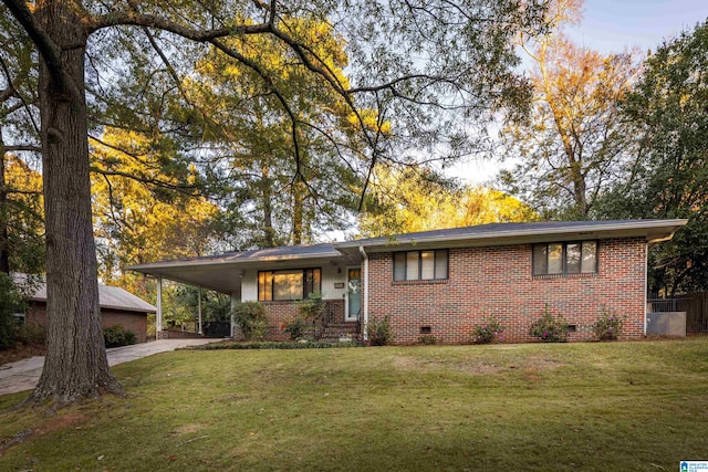 single story home featuring a front lawn and a carport