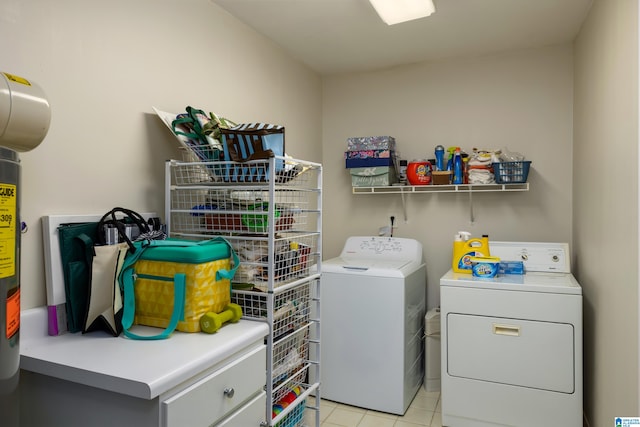 laundry area featuring washing machine and clothes dryer and light tile patterned floors