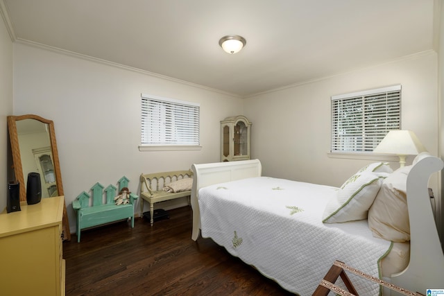 bedroom featuring multiple windows, dark hardwood / wood-style floors, and ornamental molding