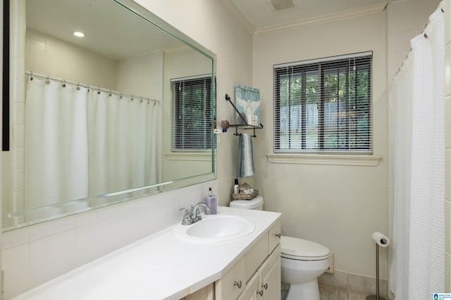 bathroom featuring vanity, toilet, walk in shower, and ornamental molding