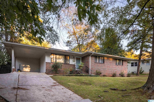 ranch-style house with a front yard and a carport