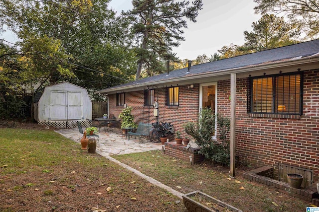 rear view of property with a patio, a storage shed, and a lawn