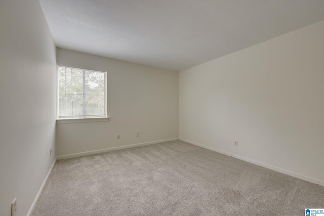 unfurnished room featuring light carpet