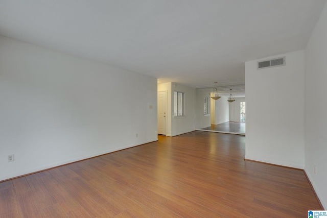 empty room with hardwood / wood-style flooring