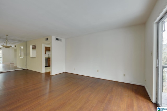 unfurnished living room with hardwood / wood-style flooring