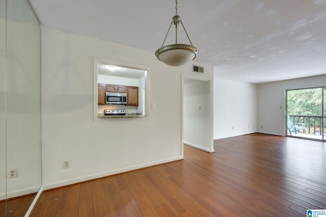 spare room featuring dark hardwood / wood-style floors