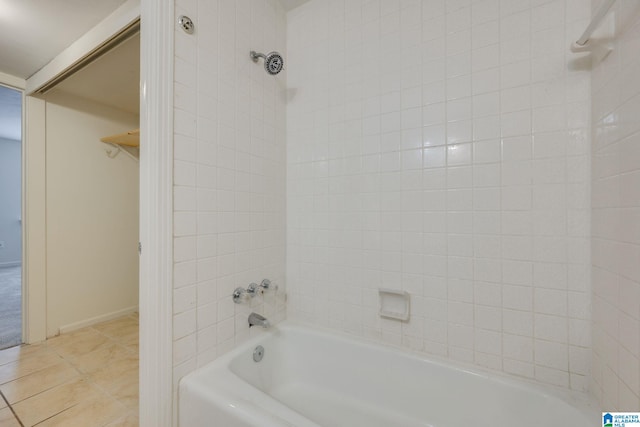 bathroom featuring tile patterned floors and tiled shower / bath