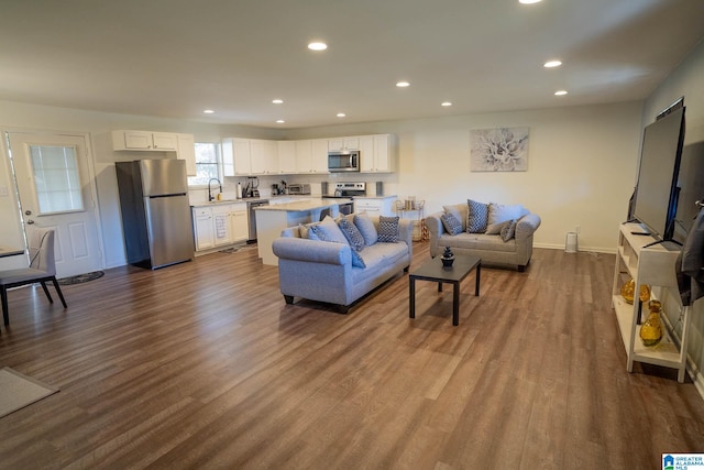 living room with sink and light hardwood / wood-style floors