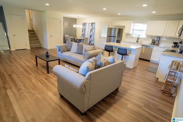 living room featuring light hardwood / wood-style floors and sink