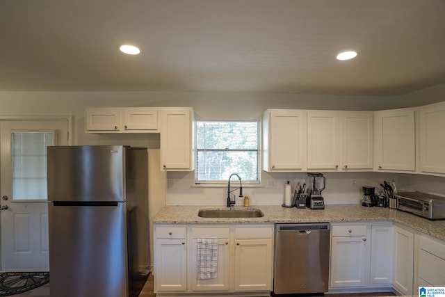 kitchen with sink, white cabinets, and stainless steel appliances