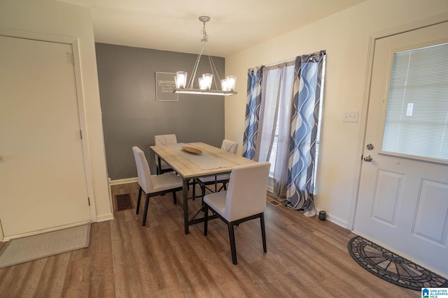 dining room featuring a chandelier and hardwood / wood-style flooring