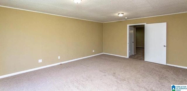 carpeted spare room with a textured ceiling and crown molding