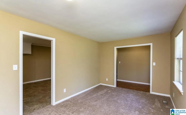 unfurnished bedroom featuring carpet flooring, a spacious closet, and a closet