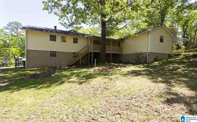 rear view of house with a yard